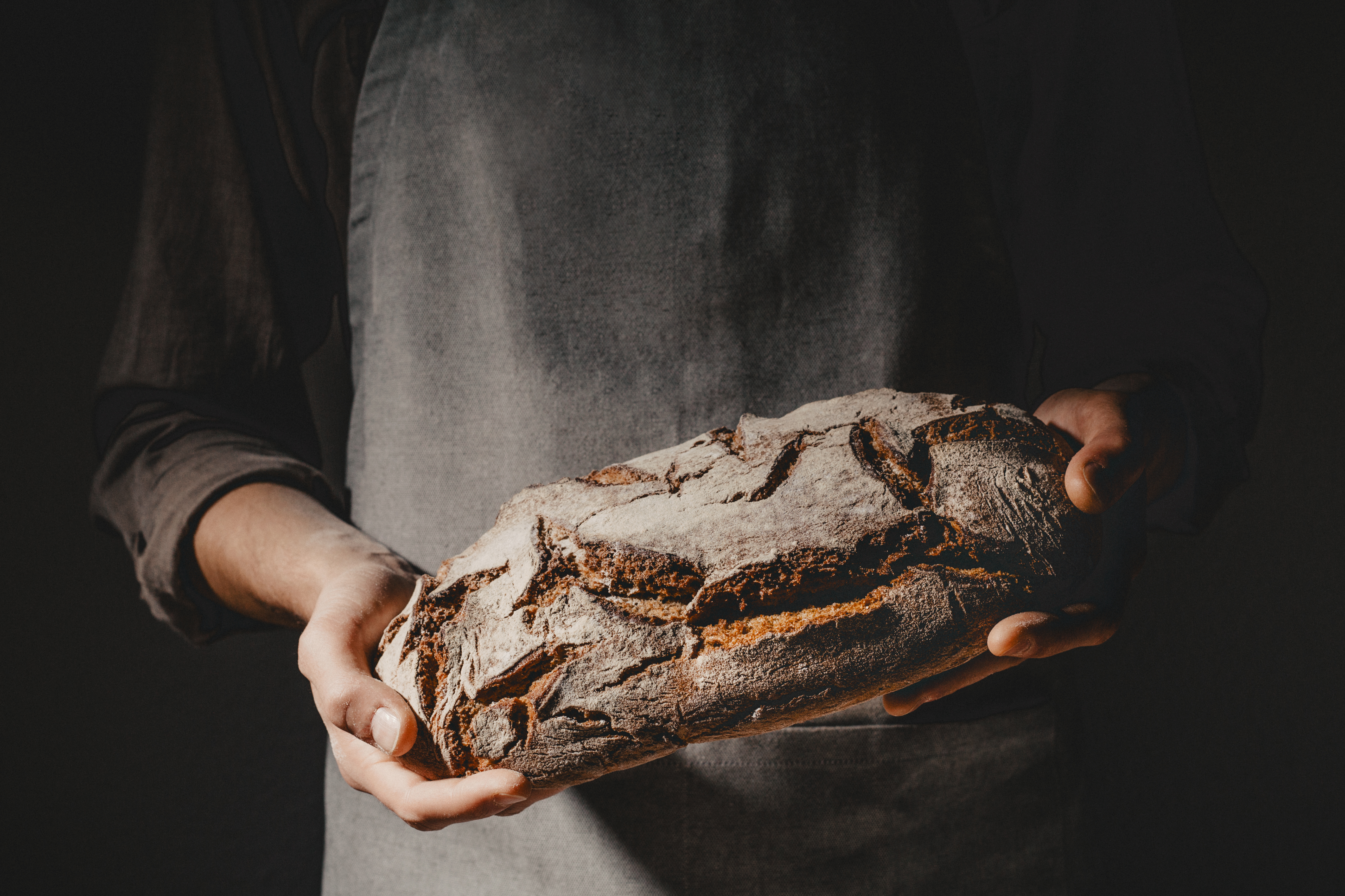 baker-holding-freshly-baked-loaf-of-bread-2026-03-10-04-51-24-utc.jpg
